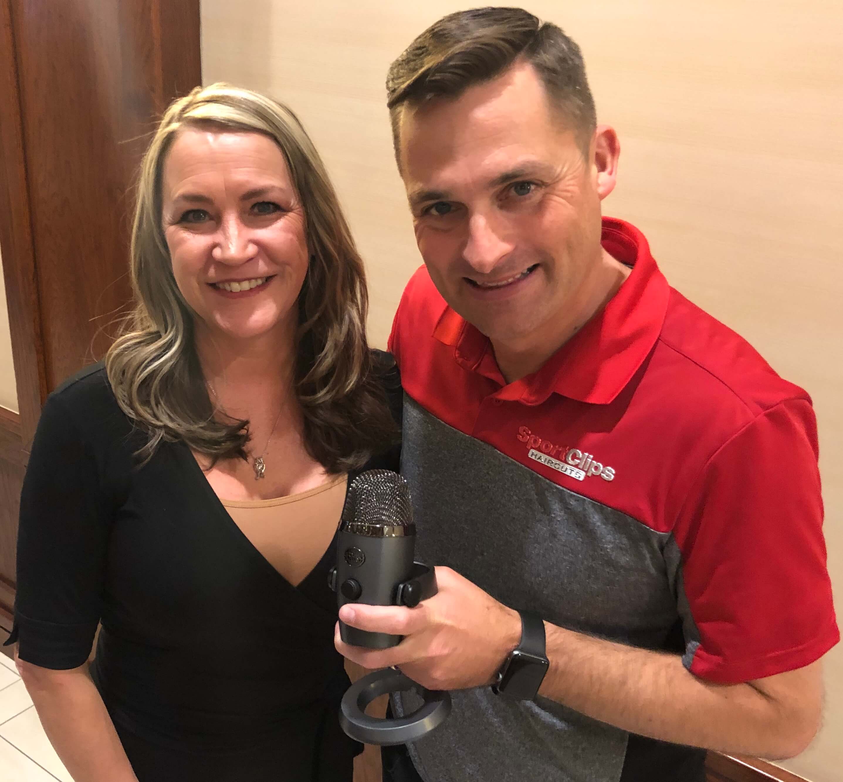 Chad Jordan and Marty Jo Endres holding a microphone